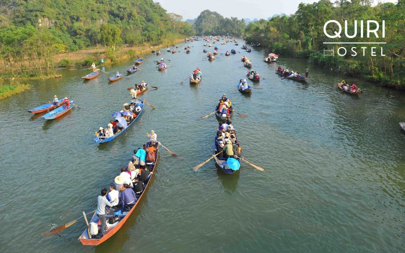 Calm waters guide visitors gently toward the Perfume Pagoda complex.