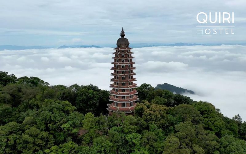 Strong winds around the tower create dramatic cloud movements near the summit.
